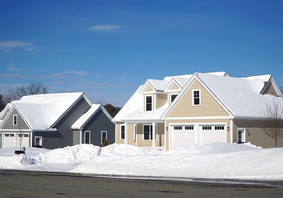 houses in residential community after snow in winter